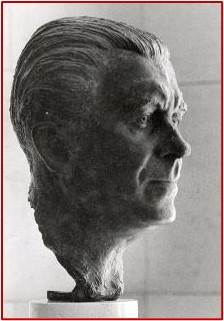 Photo of a bust showing the head of a middle-aged man, with his hair combed back to medium length.